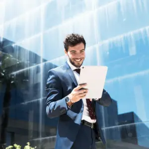Business consultant using tablet outside modern office building