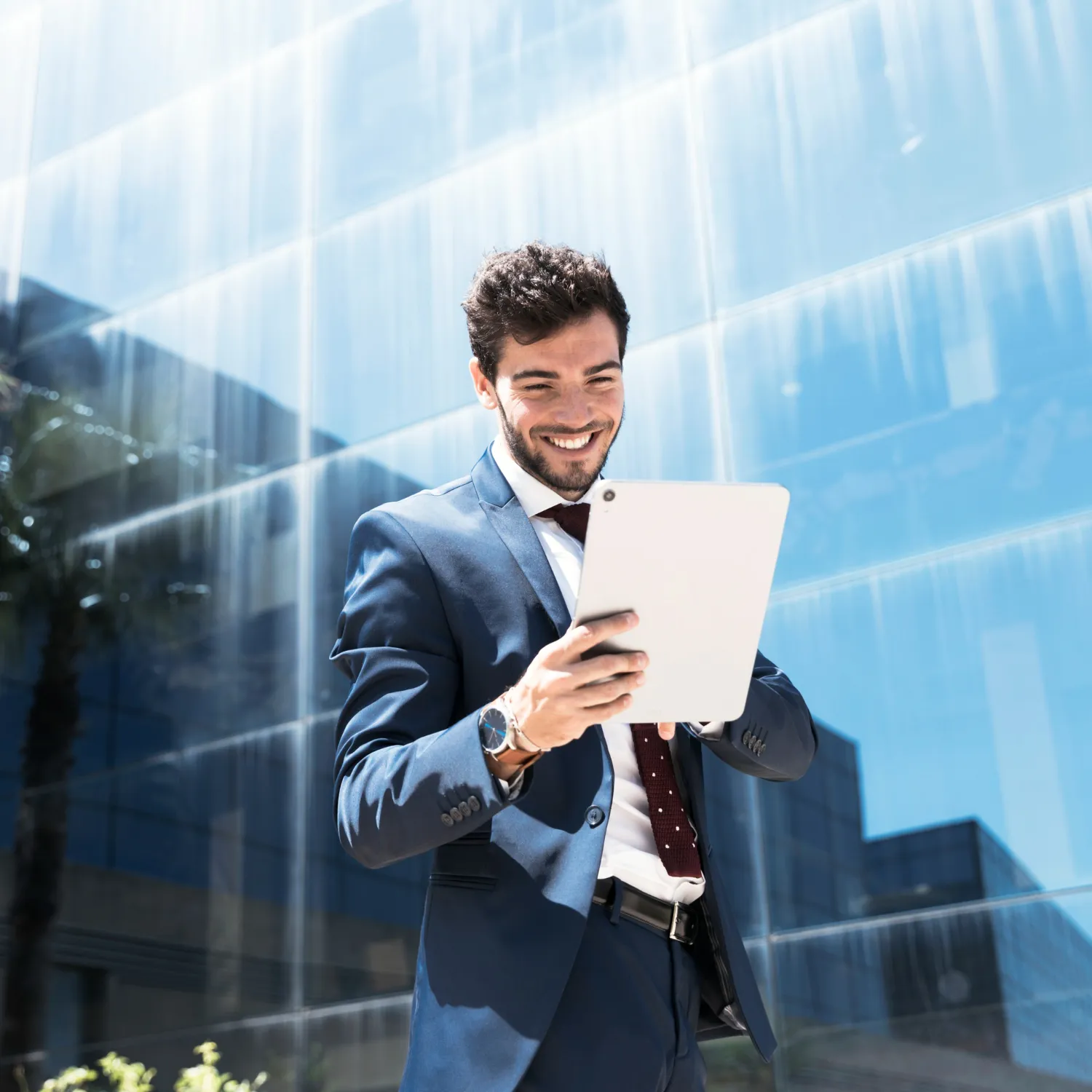 Business consultant using tablet outside modern office building