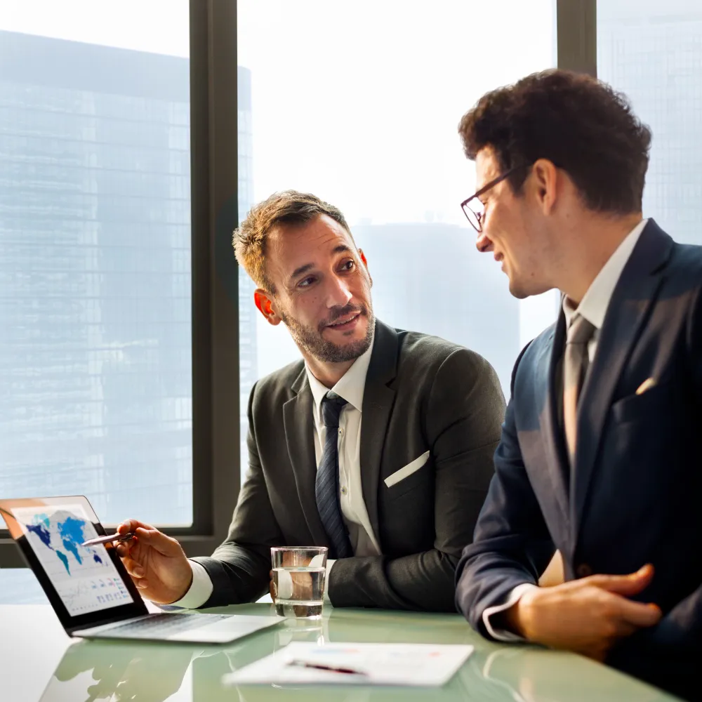 Business consultants analyzing data on a tablet during a meeting