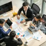 Business team analyzing charts and reports at a desk