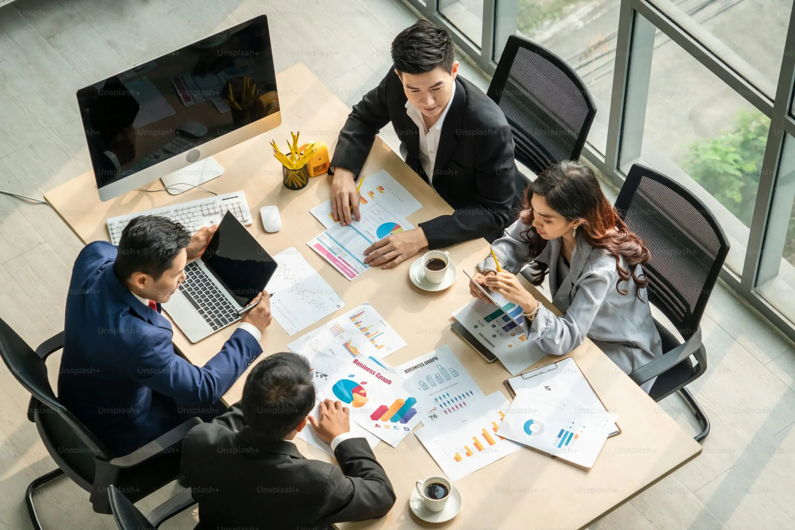 Business team analyzing charts and reports at a desk